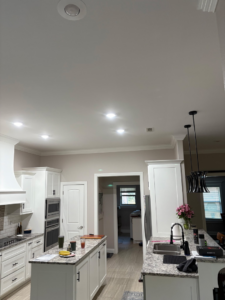 Bright recessed lighting and stylish pendant lights in a modern kitchen by 3E Enterprises, LLC in Washburn, MO.