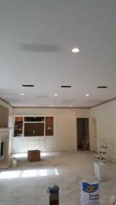 A room with newly installed recessed lighting and ceiling cutouts by Peace Of Mind Services in Sag Harbor, NY