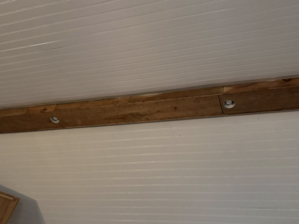 Recessed lighting fixtures installed in a ceiling with wooden beams by Power House Electrical LLC in Johnson City, TN