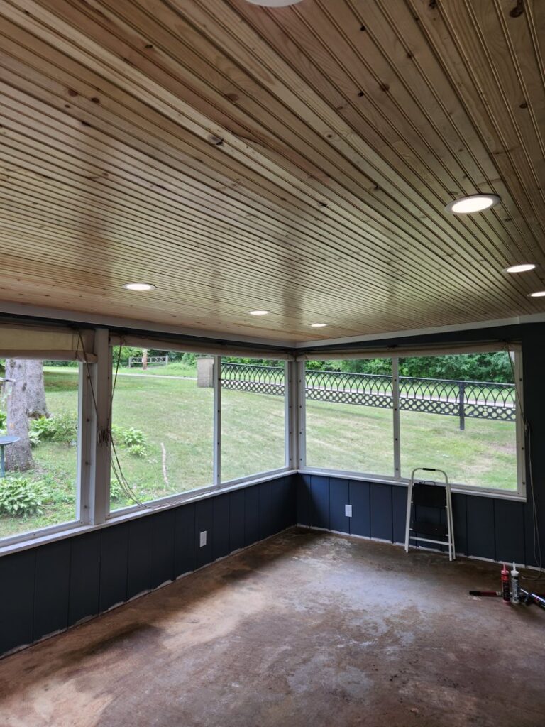 A sunroom with newly installed recessed lighting in the wooden ceiling by 715 Electric LLC in Eau Claire, WI.