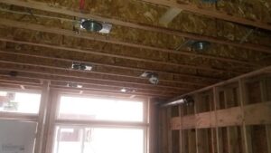 Recessed lighting fixtures being installed in a new construction ceiling by Vets Electric Company in Tacoma, WA