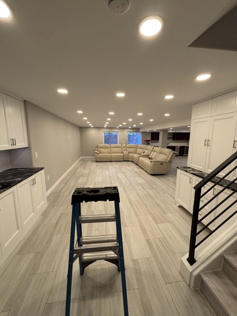 Recessed lighting installation in a large room by Wilson Electrical Contractors in Orlando, FL, with a ladder in the foreground.