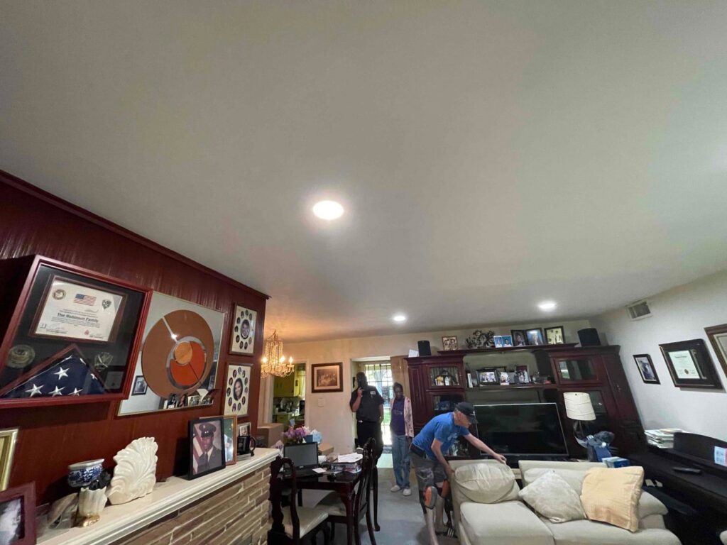 A living room with bright, newly installed recessed lighting in the ceiling, showcasing electrical upgrades by AAA Electrical Services in Sacramento, CA.