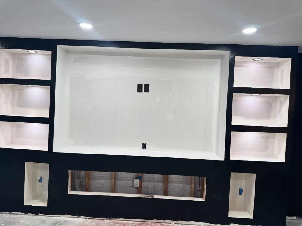 A newly installed entertainment center with recessed lighting and electrical outlets by Black Power Redevelopers in Papillion, NE.