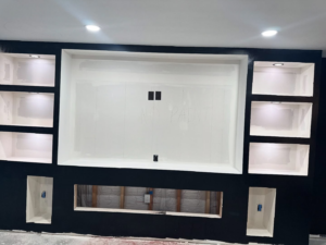 A newly installed entertainment center with recessed lighting and electrical outlets by Black Power Redevelopers in Papillion, NE.