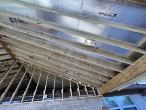 Exposed wooden ceiling framing with recessed lighting rough-in installation by Llanos Electric Builders in Houston, TX.