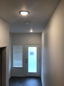 Newly installed recessed lighting and a smoke detector in a hallway by Local Electric Inc. in Kodiak, AK