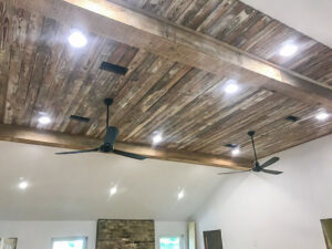 Multiple recessed lights and two ceiling fans installed in a wooden ceiling by Steadfast Electric, LLC in Baton Rouge, LA.
