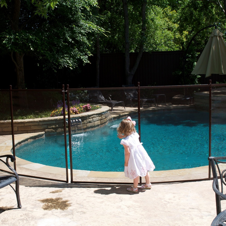A rectangular pool secured with a black mesh safety fence and gate, installed by Pool Guard in North Charleston, SC.