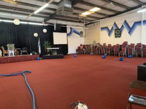 A large event space with red carpet being cleaned by DEEP CLEAN Carpet Cleaners in Beaverton, OR