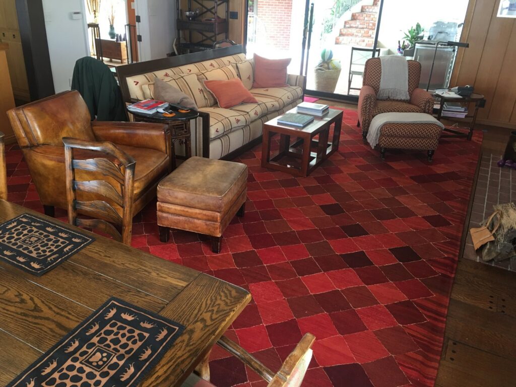 A vibrant red checkered area rug enhancing a cozy living room, installed by Ko-Z-Craft in Los Angeles, CA.