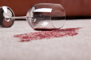 A close-up of a red wine spill on a light-colored carpet, a job for Abq Prime Carpet Cleaners in Albuquerque, NM.