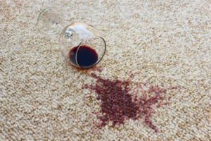 A red wine spill on a light-colored carpet, a common issue handled by Level 8 Steam Cleaning & Restoration in West Fargo, ND.