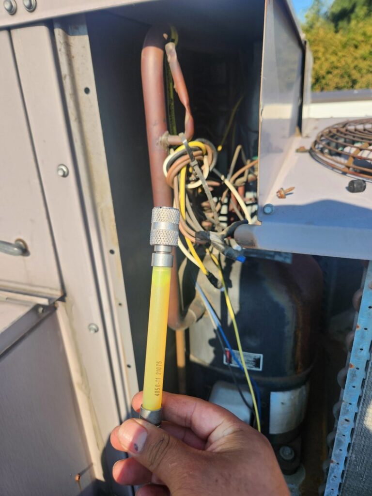 Close-up of a technician connecting a refrigerant line to an HVAC unit by HVAC Ministries LLC in Salem, OR