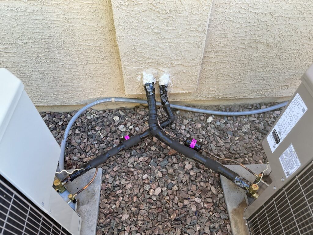 Refrigerant lines connecting two outdoor AC units during installation by Kaluas HVAC Mechanical Services in Phoenix, AZ