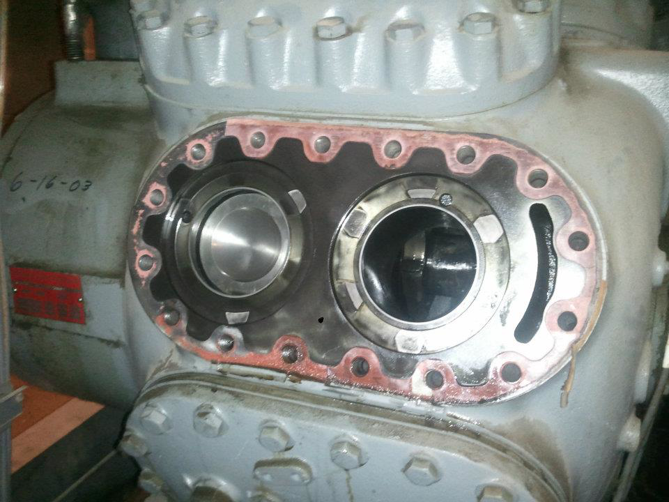 A close-up view of an open refrigeration compressor undergoing repair by Cool Fish Refrigeration, Heating, and Air in Minot, ND.