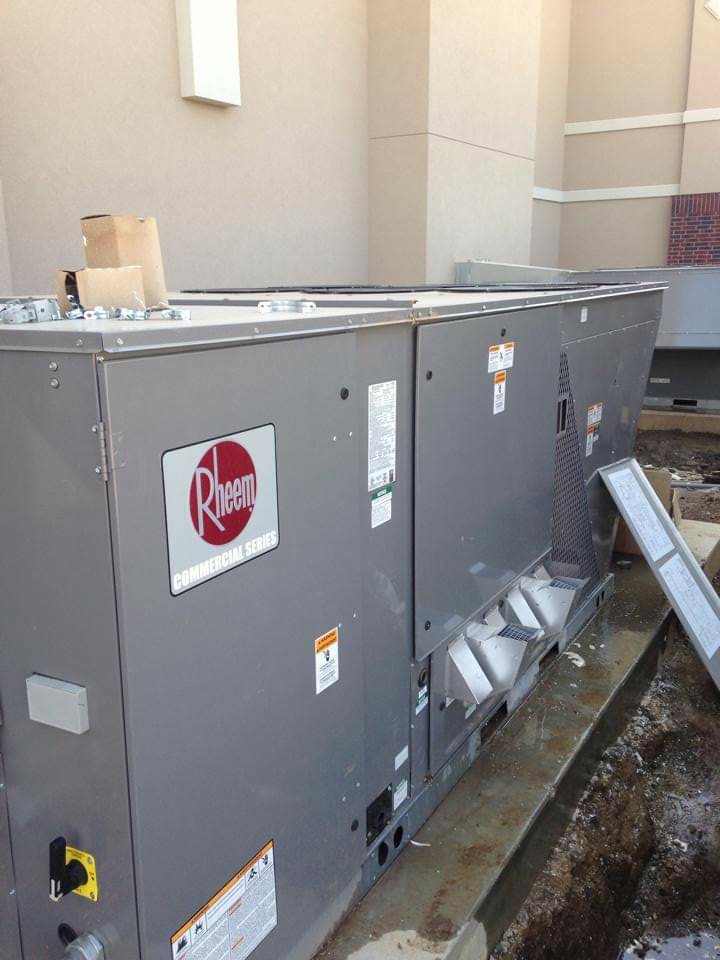 A large Rheem commercial HVAC unit installed outside a building by Griffin's Heating & Air in Tulsa, OK.
