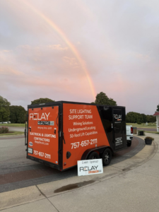 The branded Relay Electric, LLC service trailer with a rainbow in the background, showcasing electrical and lighting services in Suffolk, VA.