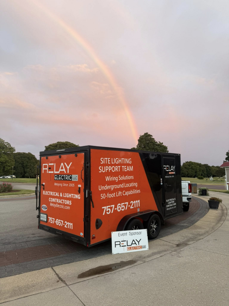 The branded Relay Electric, LLC service trailer with a rainbow in the background, showcasing electrical and lighting services in Suffolk, VA.
