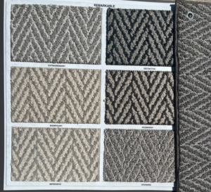 A display board showcasing six chevron-patterned carpet samples from the Remarkable collection by Erin Wruck Consulting LLC in Converse, TX