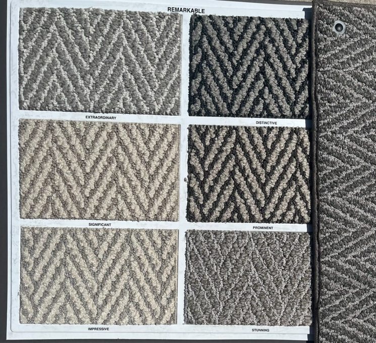 A display board showcasing six chevron-patterned carpet samples from the Remarkable collection by Erin Wruck Consulting LLC in Converse, TX