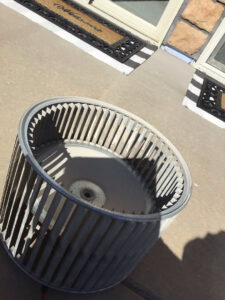 A dirty furnace blower wheel removed for cleaning or replacement by Waymaker HVAC LLC in Colorado Springs, CO.