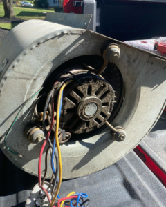 A removed HVAC blower motor assembly ready for repair or replacement by B & H Heating and Air Services LLC in Local City, ST.