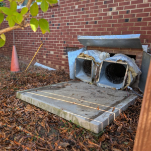 Removed HVAC ductwork and a concrete pad, indicating a system replacement by Speedy Nelson HVAC Repair in Durham, NC.