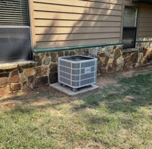 A newly installed residential AC condenser unit by Chapman HVAC outside a home in Cleveland, OK.
