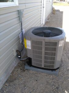A new residential AC condenser unit installed next to a house by Jv Services inc. in Pinellas Park, FL.