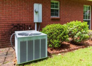 A residential AC condenser unit installed outside a home by Rhode Island HVAC Services in Providence, RI.