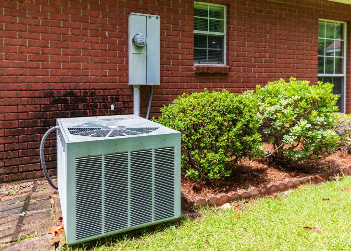 A residential AC condenser unit installed outside a home by Rhode Island HVAC Services in Providence, RI.