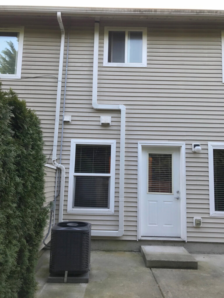 A residential air conditioning unit installed outside a home by Columbia Heating & Air Conditioning in Kent, WA.