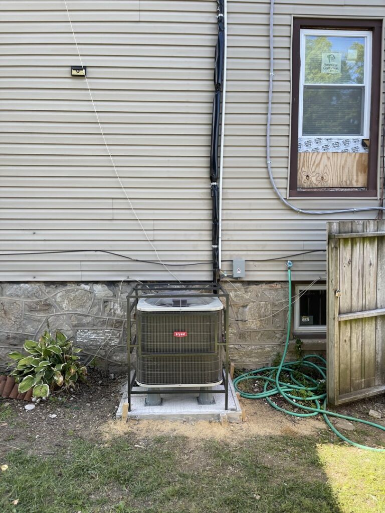 A residential air conditioning unit with a protective cage installed by GT Mechanical Services in Baltimore, MD