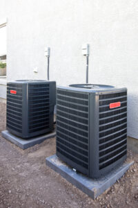 Two residential outdoor air conditioning units installed by Basic HVAC in Indianapolis, IN.