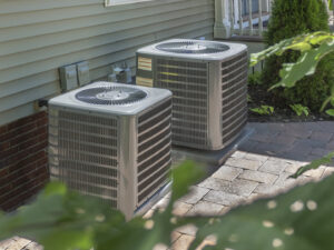 Two outdoor air conditioning units installed next to a residential building by Reliable Heating and Air LLC in Summerville, SC.
