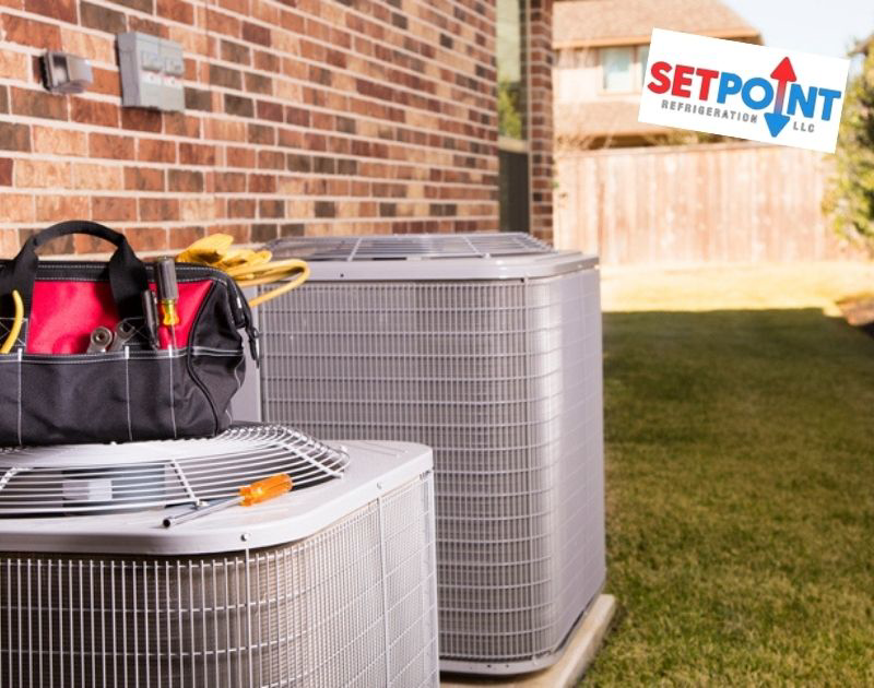 Two residential outdoor AC units with a tool bag nearby, indicating service by Setpoint Refrigeration LLC in Liberty Hill, TX