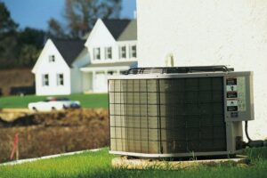 A residential air conditioning unit installed outside a home by Isaac Heating & Air Conditioning in Rochester, NY.