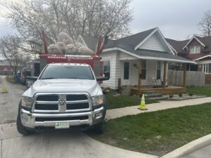 A Vacman Air Duct Cleaning truck with debris bags parked outside a residential home in South Bend, IN