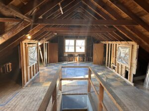 Residential attic with exposed wiring during electrical rough-in by Advance Electrical Contractors in Milwaukee, WI.