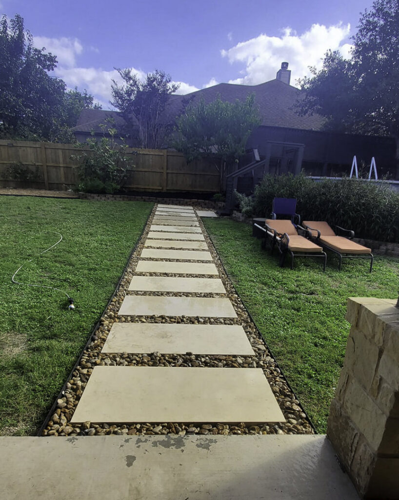 A sturdy wooden fence enclosing a residential backyard by Waldemar Landscape & Design in Austin, TX