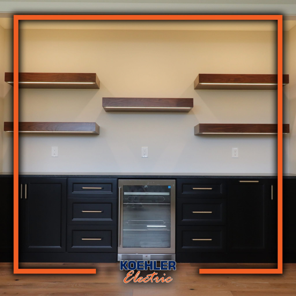 Residential bar area with illuminated floating shelves and electrical outlets installed by Koehler Electric in Davenport, IA.