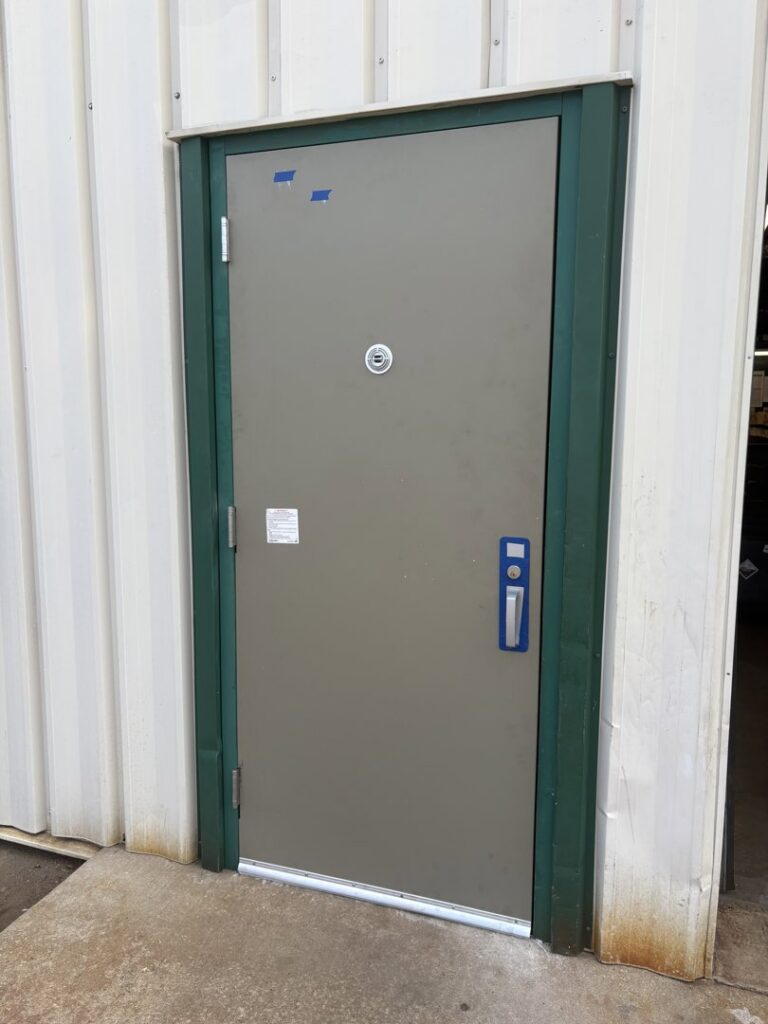 Two residential beige garage doors with decorative trim installed by Ozarks Overhead Door & More in Springfield, MO.