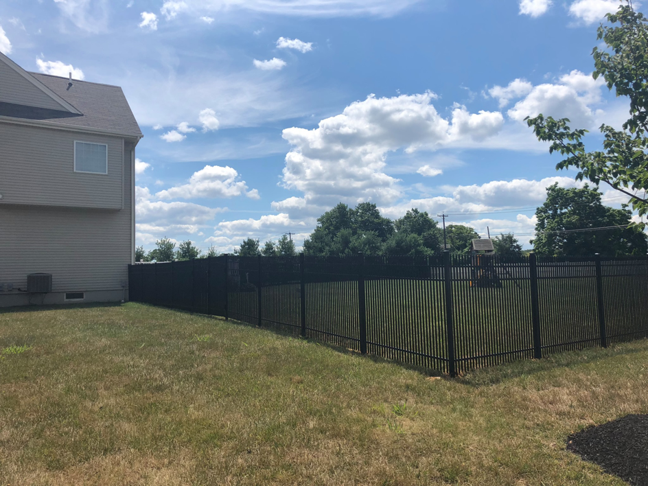 A black aluminum fence installed around a residential property by Mercer Fence Company in Hamilton Township, NJ.