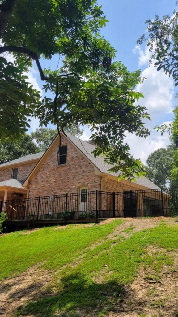 A residential black metal fence installed around a house by A-1 Security Fence in Scott, LA.