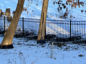 A section of residential black metal fence installed in a snowy landscape by GoldHammer, a contractor in Sebastopol, CA.