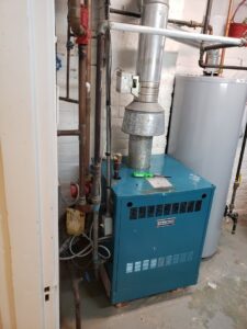 A residential boiler heating system in a basement, serviced by Booker Heating & Air in Richmond, VA.