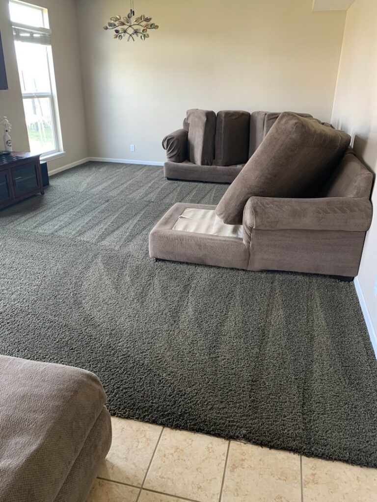 A residential living room with sofas and a freshly cleaned carpet showing vacuum lines by 765 Custom Cleaners in Lafayette, IN.