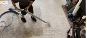 A professional cleaning a light-colored residential carpet, showing a clear before and after, by JS Carpet Cleaning in San Jose, CA