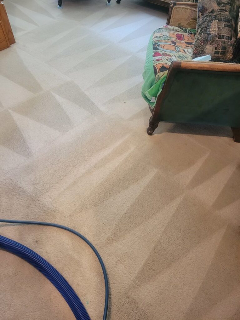 Residential carpet freshly cleaned with distinct patterns and a blue hose by Yellow Van Cleaning & Restoration in Kearney, NE